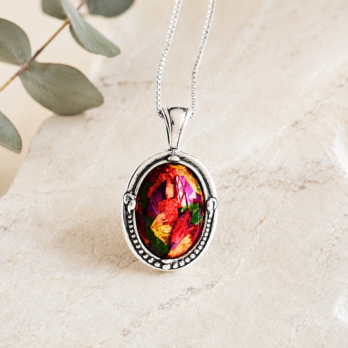 Harmony Oval Pendant with colorful preserved flowers in a sterling silver setting.