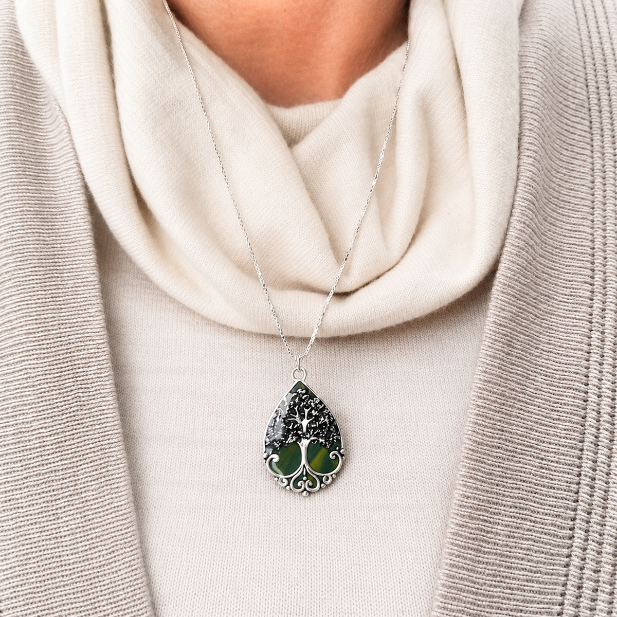 Model wearing Harper Memorial Pendant with green preserved flowers in a silver tree design.