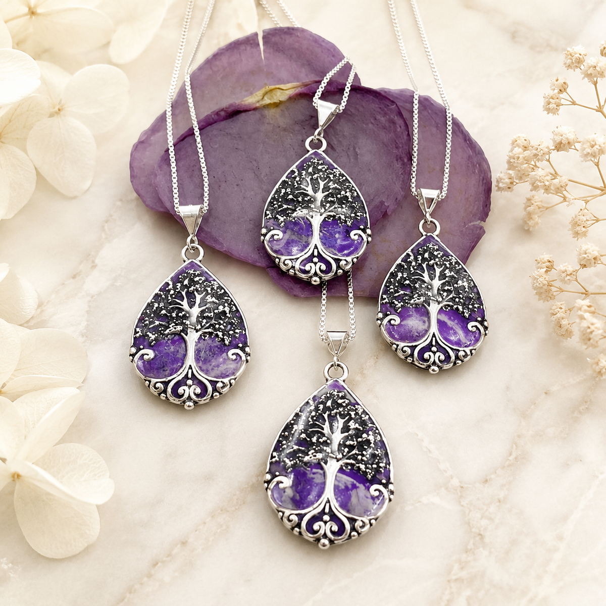 Four Harper Memorial Pendants with purple preserved flowers in silver tree designs.
