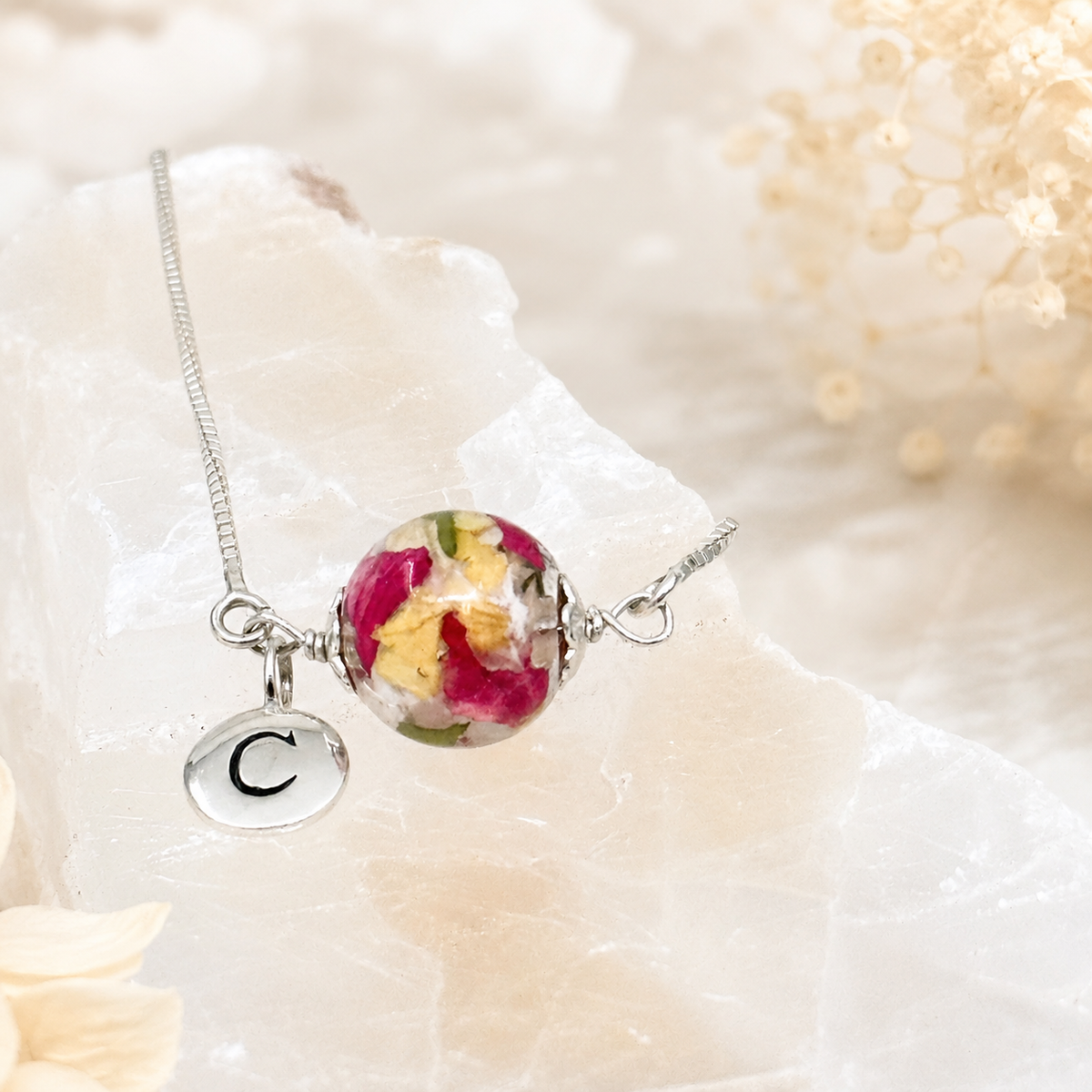 Keepsake Petal Memorial Bracelet with pink and yellow preserved flowers and initial charm.