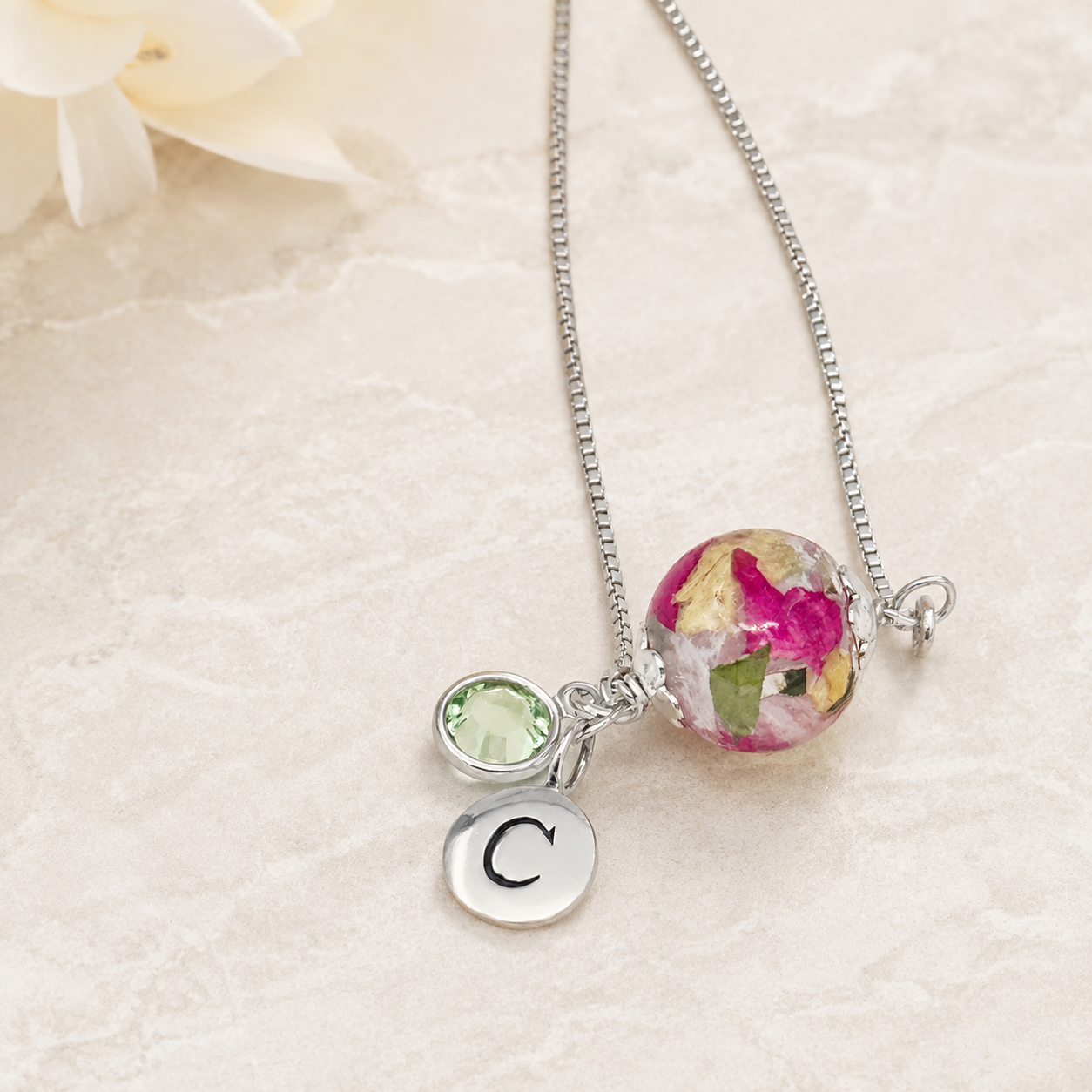 Keepsake Petal Memorial Bracelet with pink and yellow preserved flowers, birthstone and initial charm.