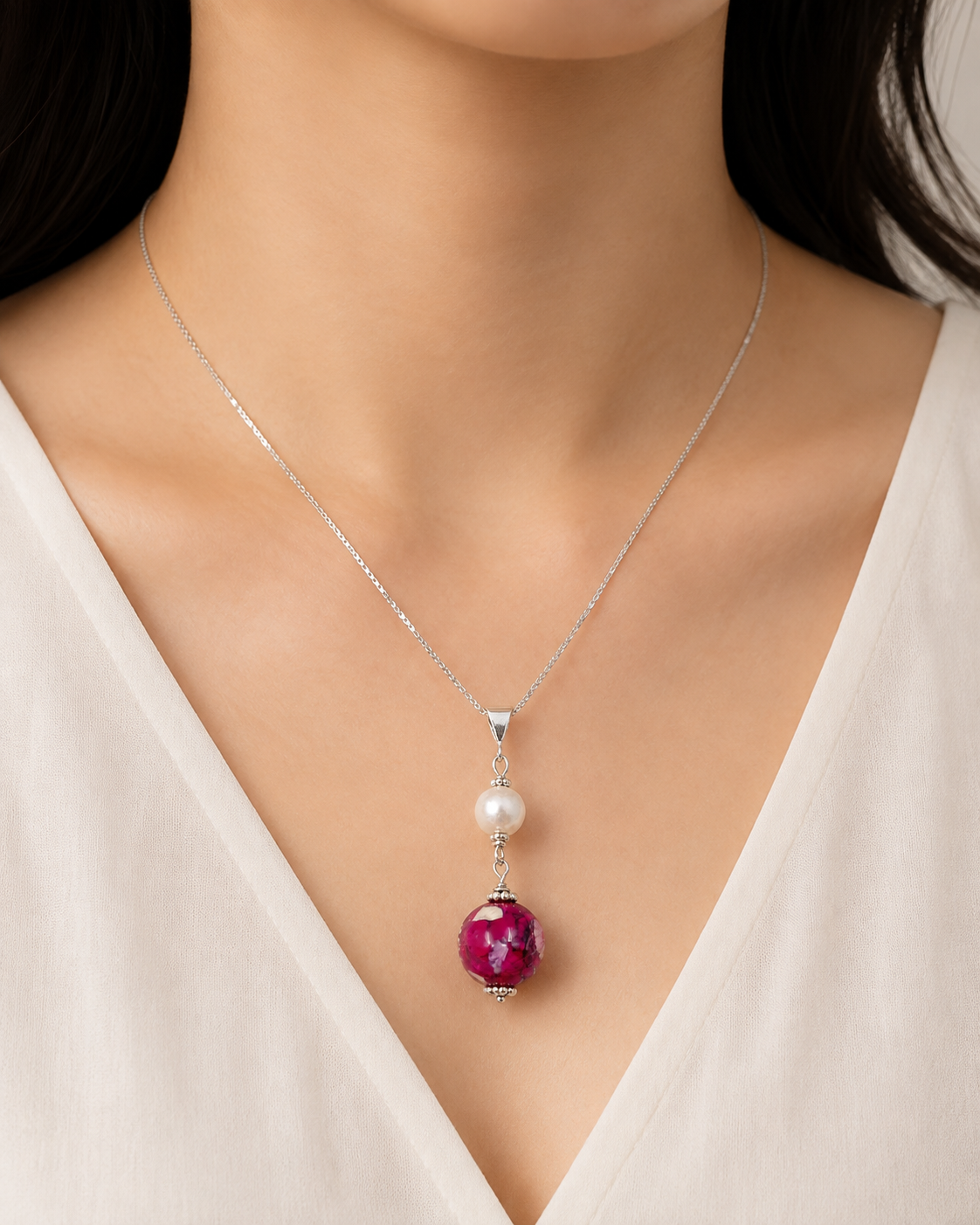Model wearing Pearl Embrace sterling silver flower keepsake necklace