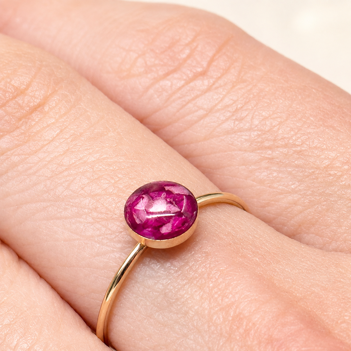 Model wearing Petite Eternity Gold-Plated Stackable Ring with pink preserved flowers.