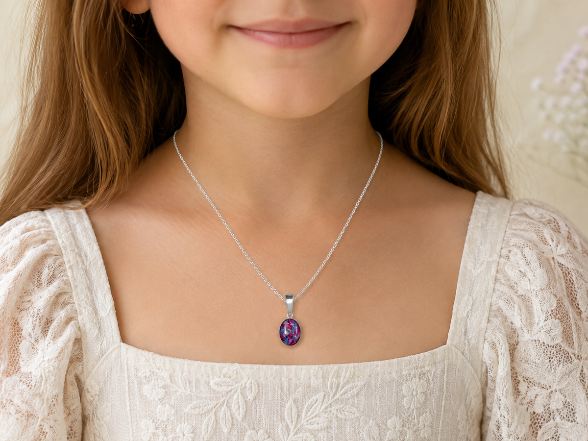 Child wearing petite sterling silver flower keepsake necklace