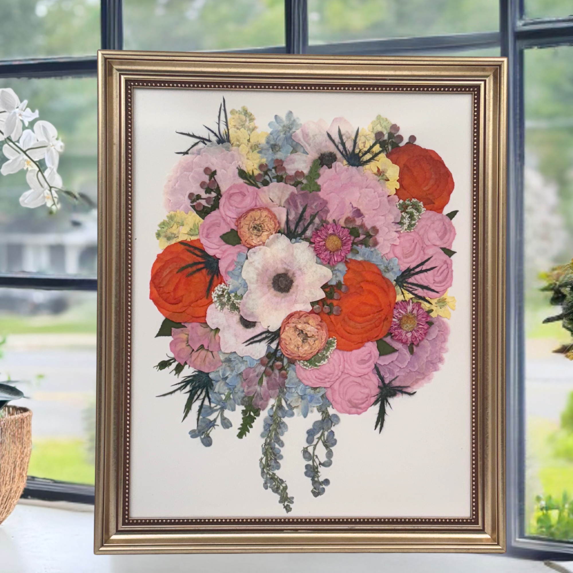 16x20 pressed flower artwork featuring a vibrant wedding bouquet with pink, orange, purple, and white blooms, framed in an elegant gold frame.