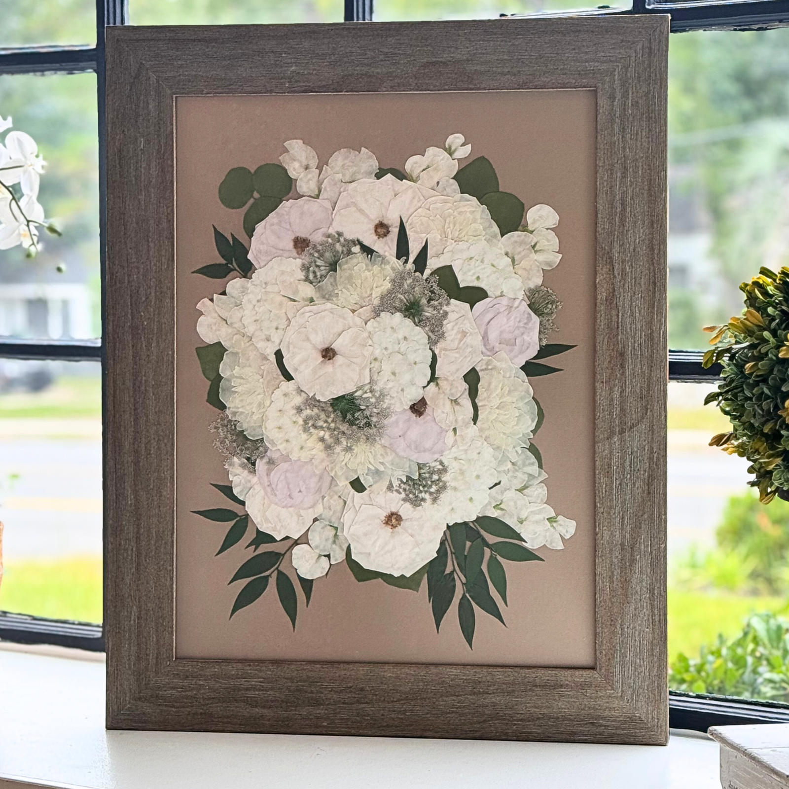 18x24 framed pressed flower artwork featuring a preserved white wedding bouquet with greenery, displayed in a rustic wood frame.