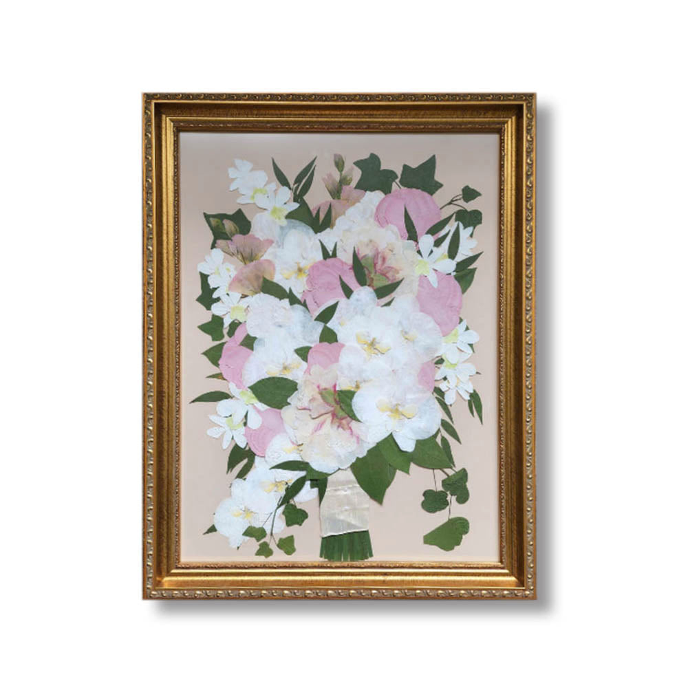 18x24 pressed flower artwork featuring a preserved pink and white wedding bouquet with greenery, displayed in an ornate gold frame.