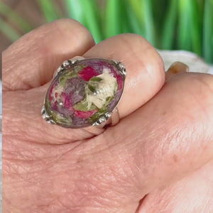 Video showing a handcrafted memorial flower ring made with preserved funeral flowers, displayed on a model’s finger in a full 360-degree view to show the design and details.