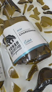 Custom framed wedding wine bottle art featuring preserved original labels and shattered glass arranged into a personalized keepsake by Flowers Forever.