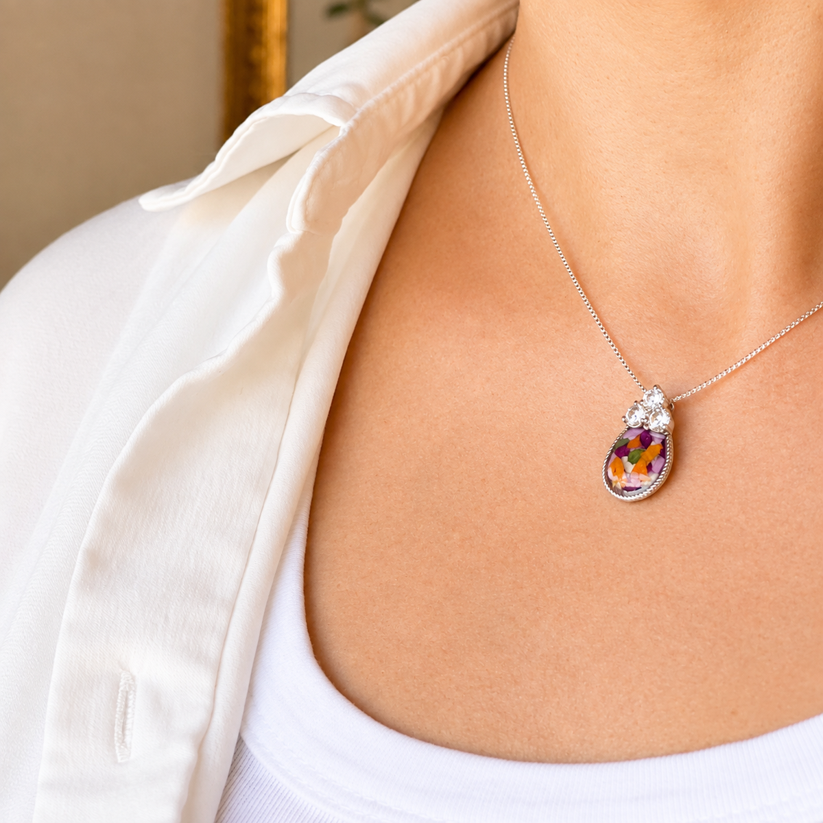 Model wearing Forever in My Heart Pendant with colorful preserved flowers.