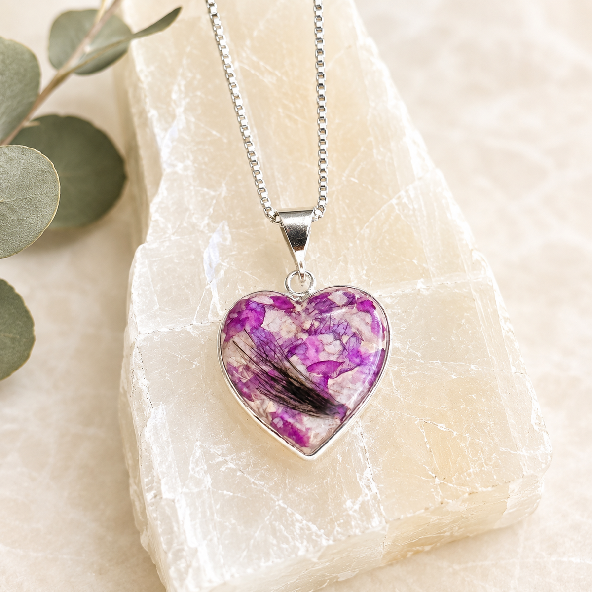 Remembrance Heart Pendant with purple preserved flowers and a lock of hair.