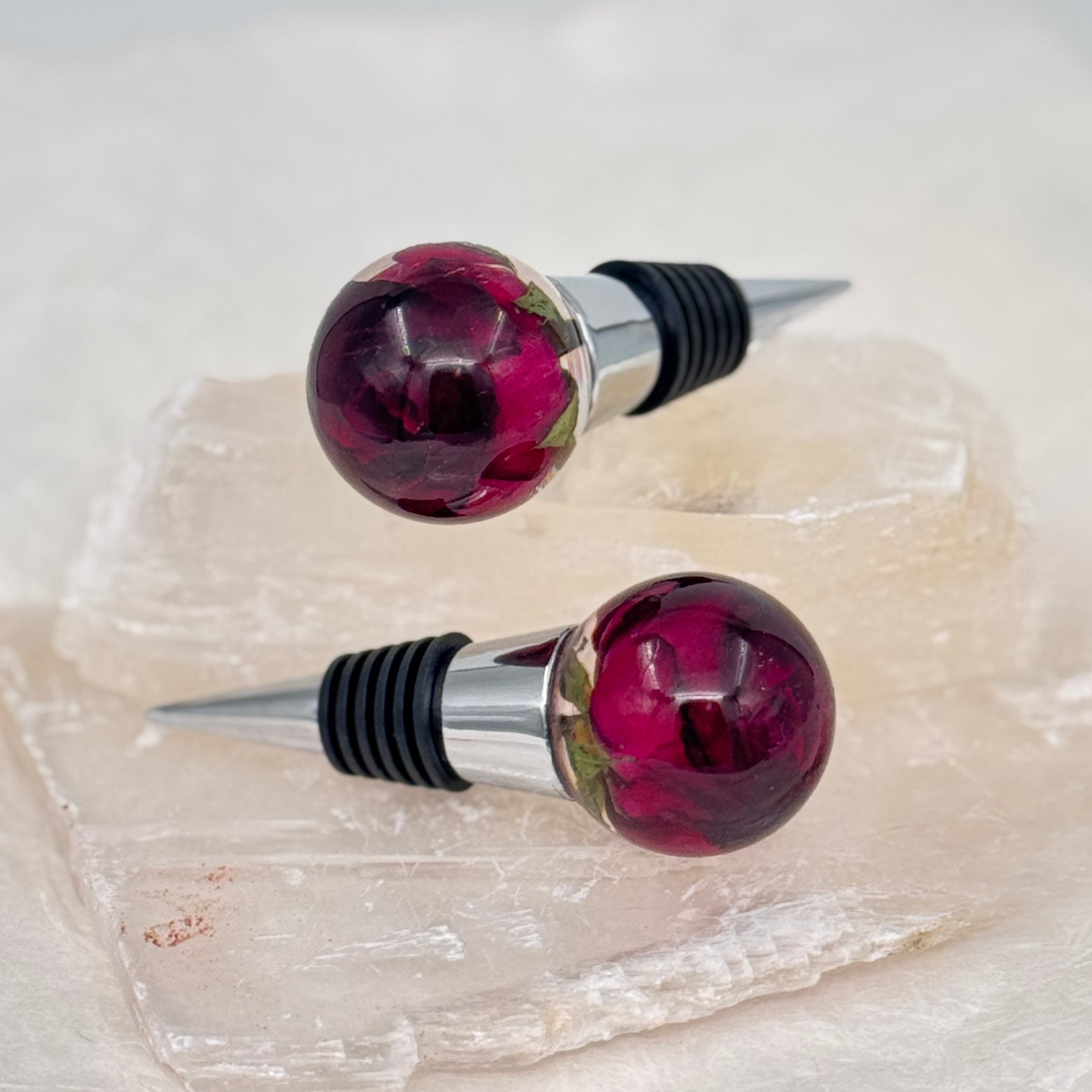 Handcrafted resin wine stopper made with preserved red roses, a unique floral keepsake designed for weddings, memorials, or special celebrations.