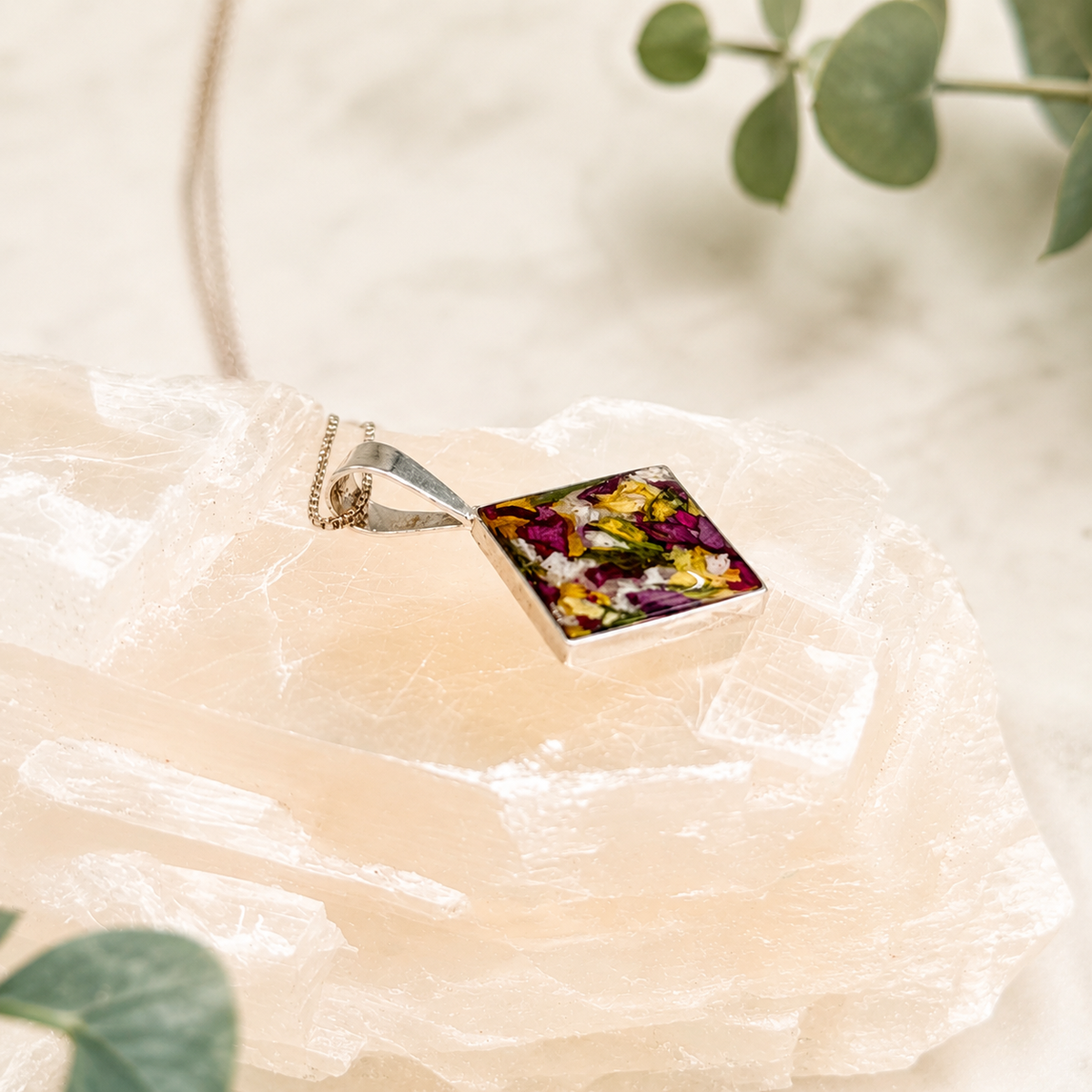 The Keepsake Diamond Pendant with purple, yellow and white preserved flowers.
