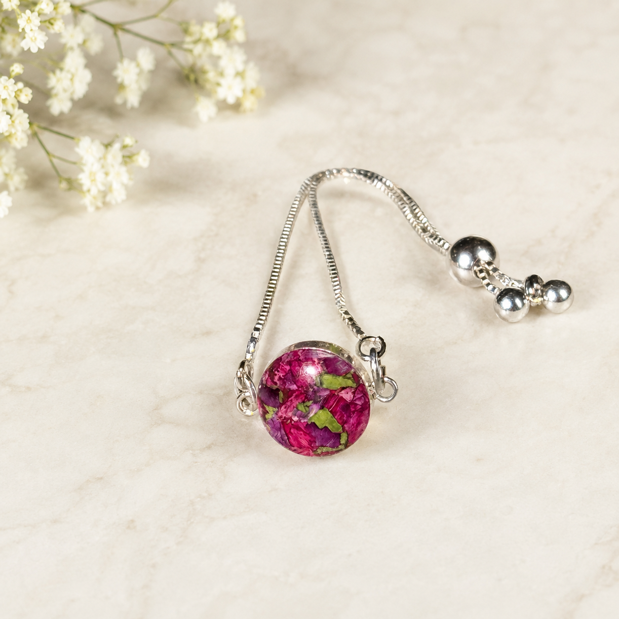 Timeless Blossom Bracelet with pink and green preserved flowers in a silver setting.