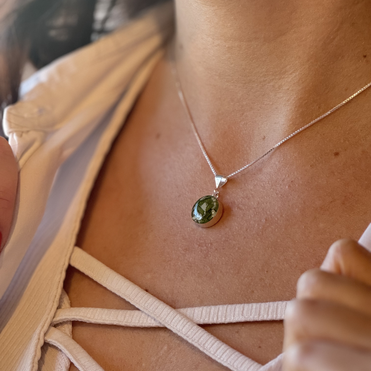 Model wearing Timeless Blossom Pendant with green preserved flowers