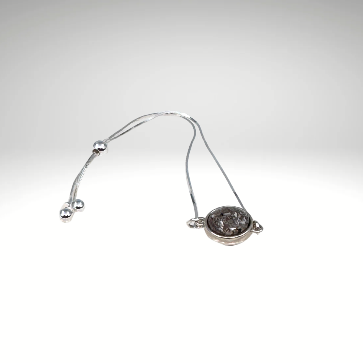 Close-up of the Two Souls Pet Memorial Bracelet showing the bead with cremation ashes preserved in resin.