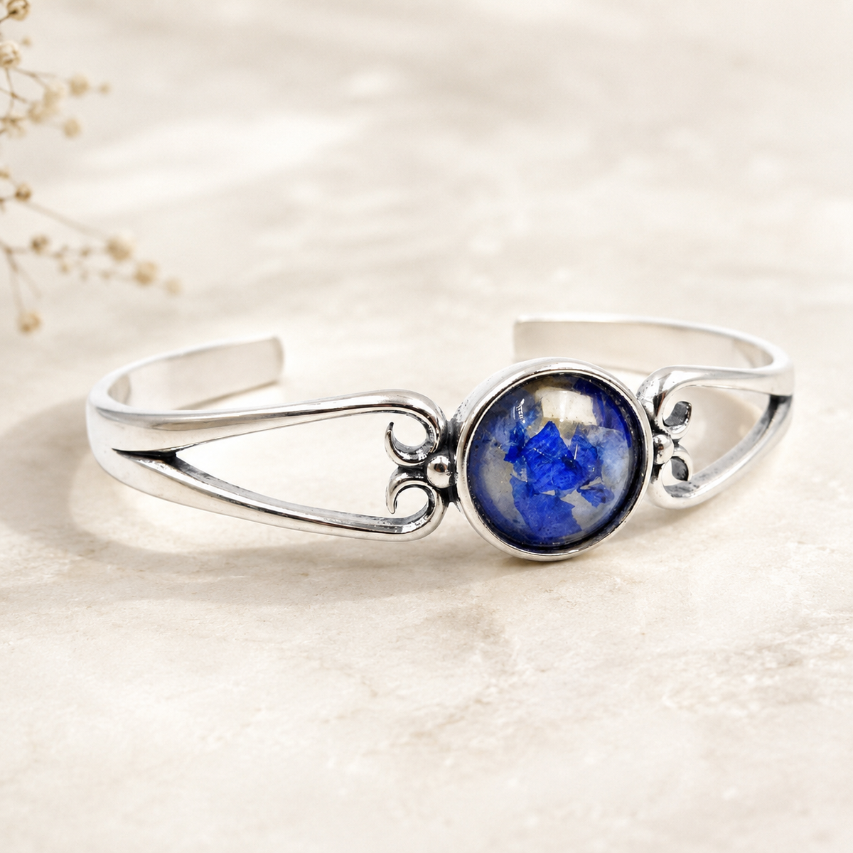 Unity Memorial Bracelet with blue preserved flowers in a silver setting.