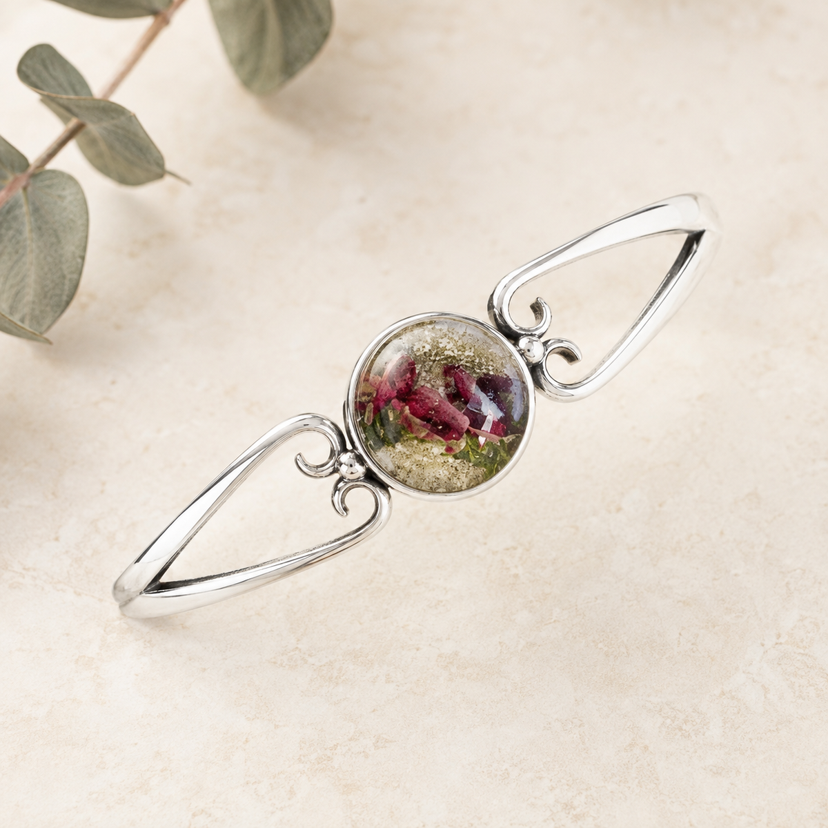 Unity Memorial Bracelet with red and green preserved flowers in a silver setting.