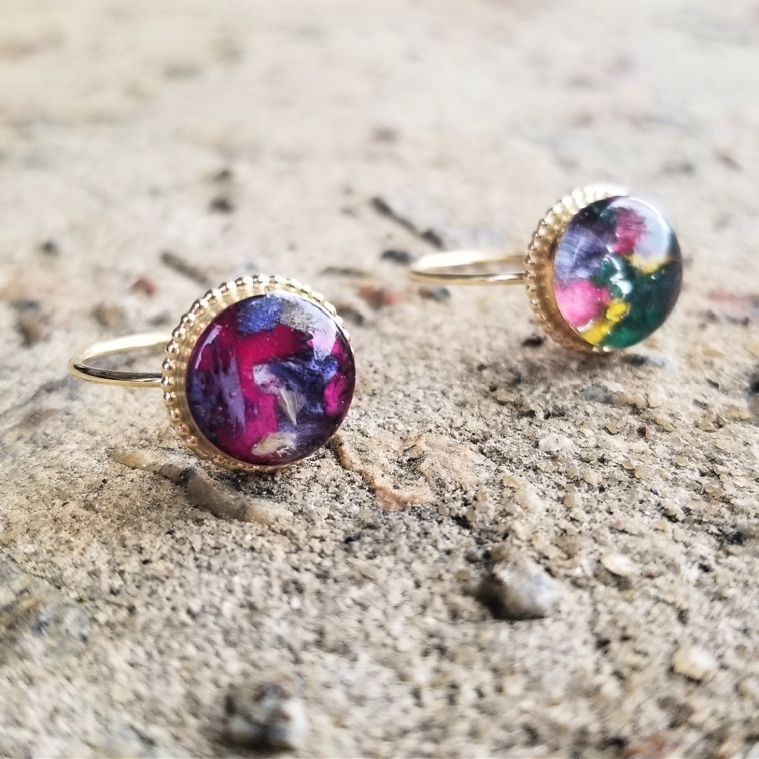 Sterling silver and gold-plated versions of the Circle of Memories Ring shown together.