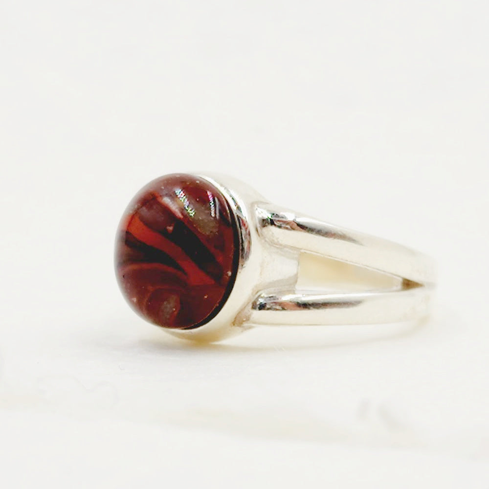 A detailed close-up of the Daisy Pet Memorial Ring, showing the intricate swirls of pet fur or ashes in a custom design.