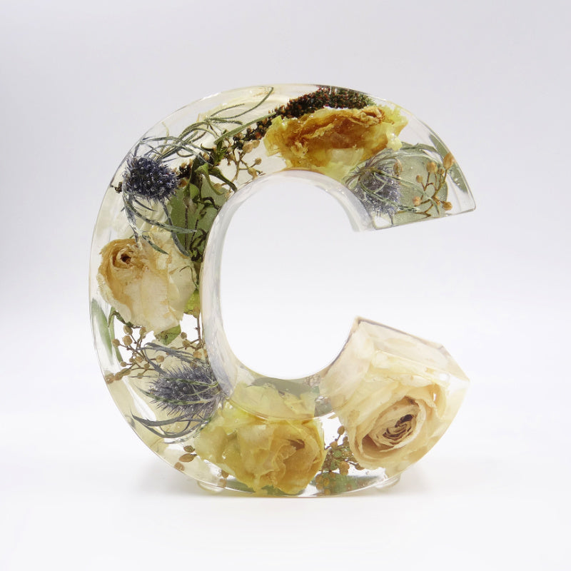 Clear resin letter C filled with light pastel preserved flowers from wedding or funeral bouquet, personalized floral keepsake
