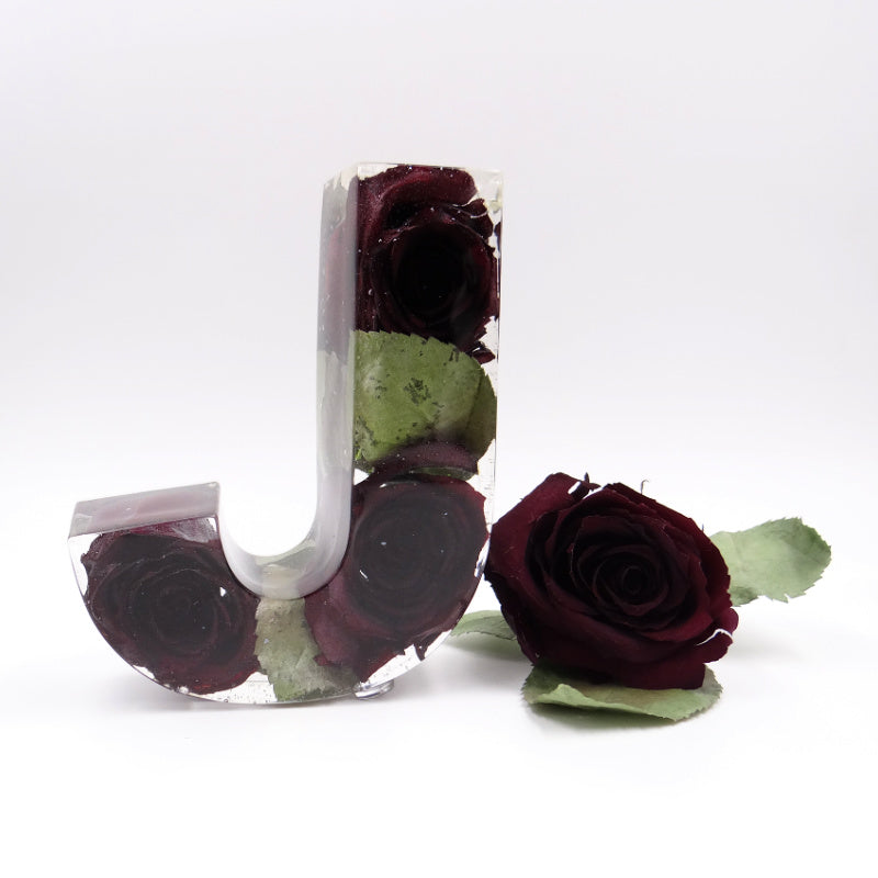 Clear resin letter J featuring preserved dark red roses from wedding or funeral bouquet, elegant floral keepsake
