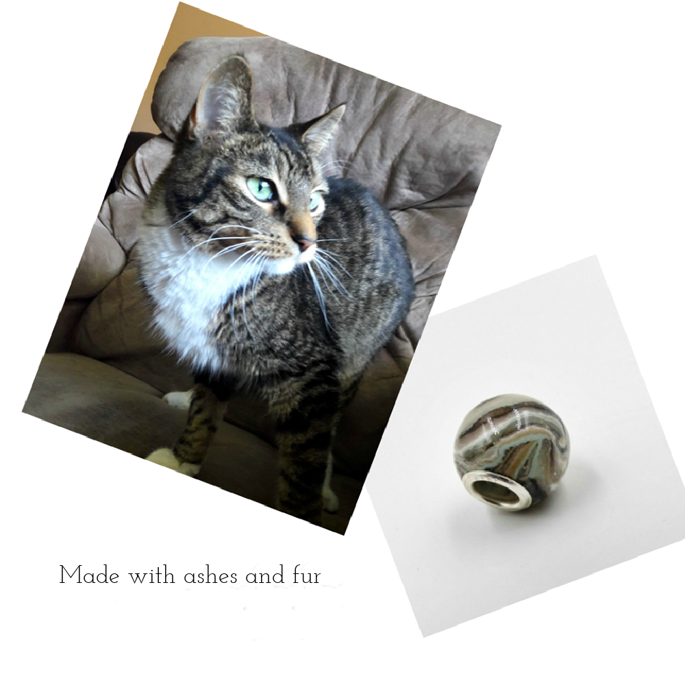 A custom pet memorial bead crafted to reflect a cat’s blue-eyed fur pattern, infused with ashes or fur for a lasting tribute.