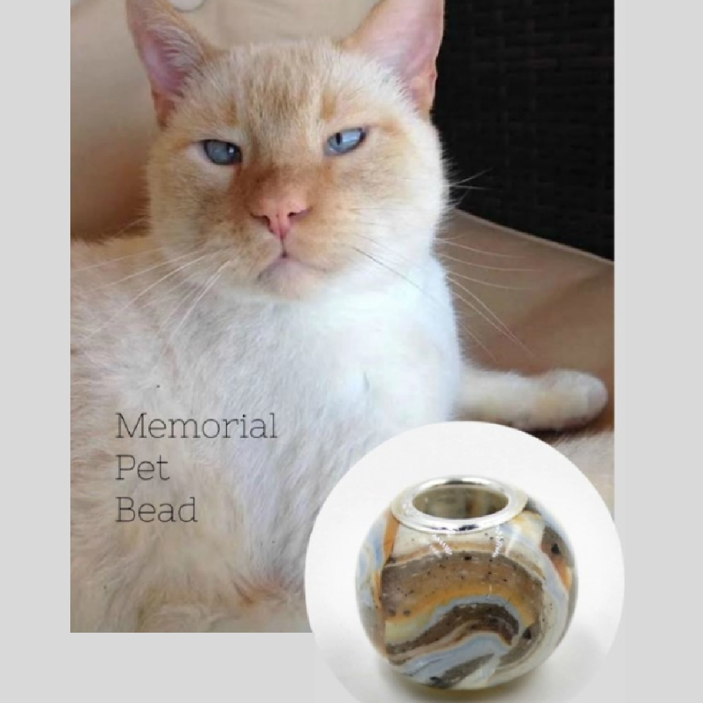 A close-up of the Forever Fur Memorial Bead, showcasing soft blue, cream, and grey tones inspired by a beloved cat’s fur pattern.