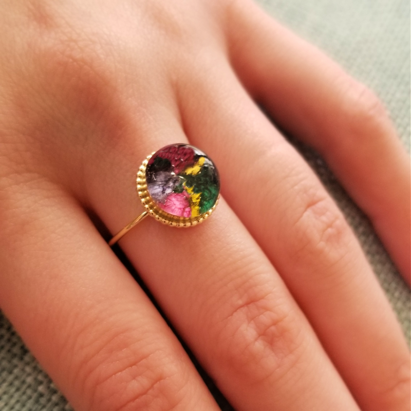 Model wearing the Circle of Memories Gold-Plated Ring featuring preserved flowers.