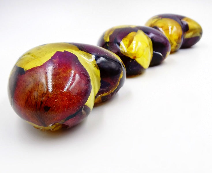 Three large resin hearts viewed from the side, showcasing floral details.