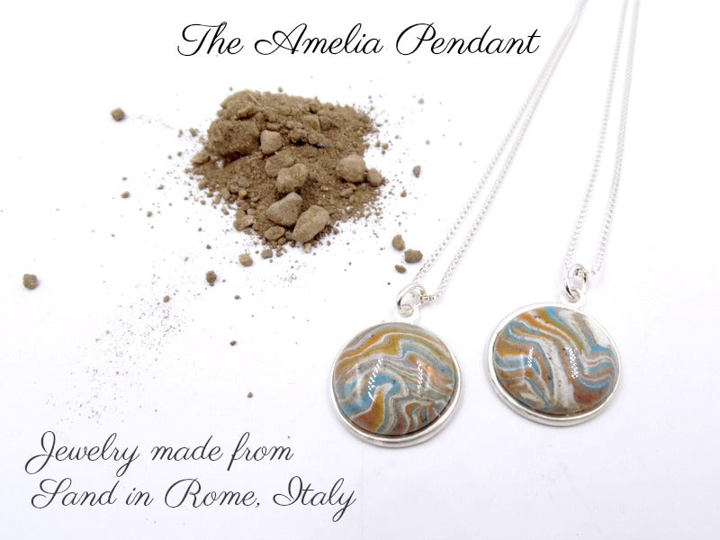 Sterling silver round pendant with a brown, light blue, and white clay swirled with sand from Rome, Italy.