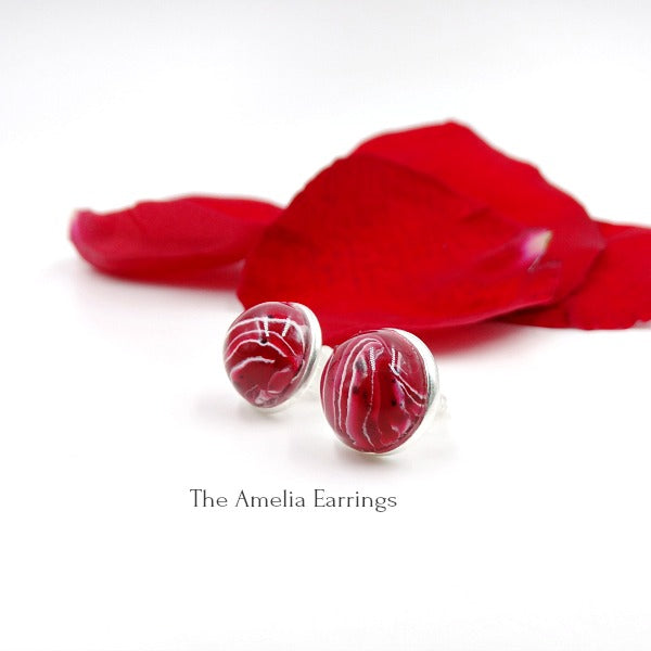 Round Sterling silver earrings with red, and white clay swirled with flowers.