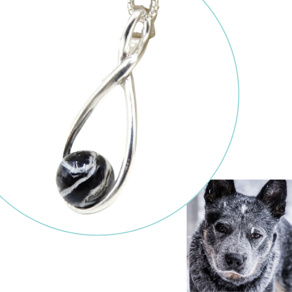 Custom pet memorial pendant infused with ashes or fur, designed to match a black and white dog’s unique fur pattern.