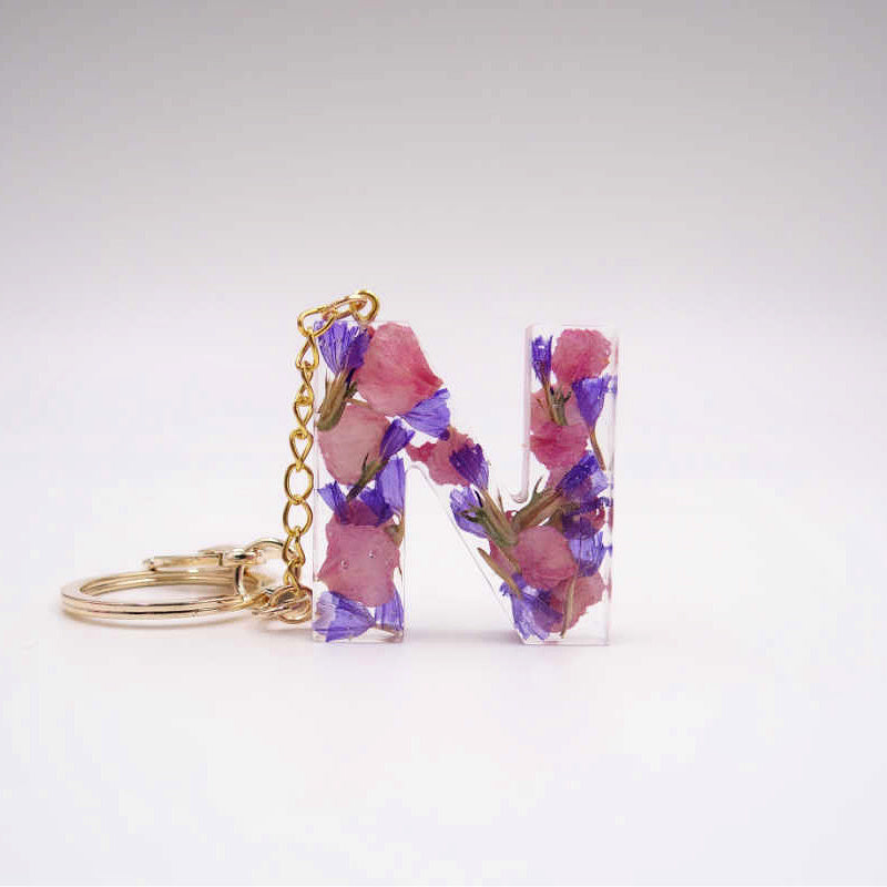 Floral resin keychain in letter N with preserved petals, custom memory keepsake from your flowers

