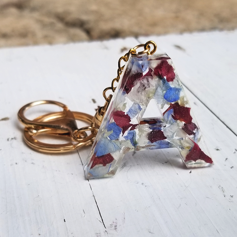 Resin letter A keychain with preserved red, white, and blue flower petals, custom memorial or patriotic keepsake