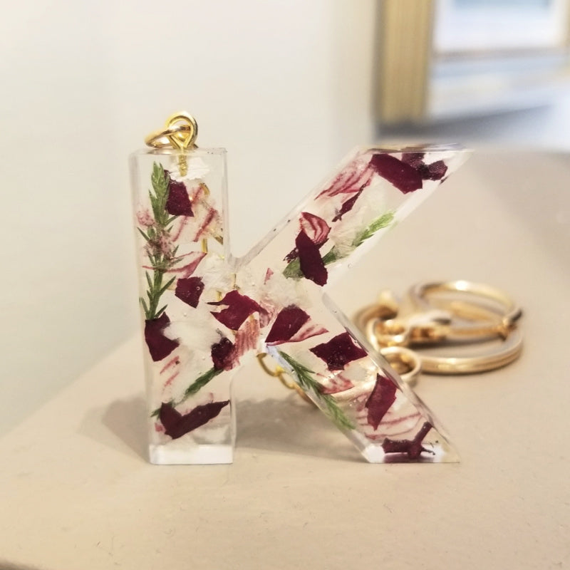 Resin keychain in letter K with preserved multi-color flower petals, handmade floral keepsake