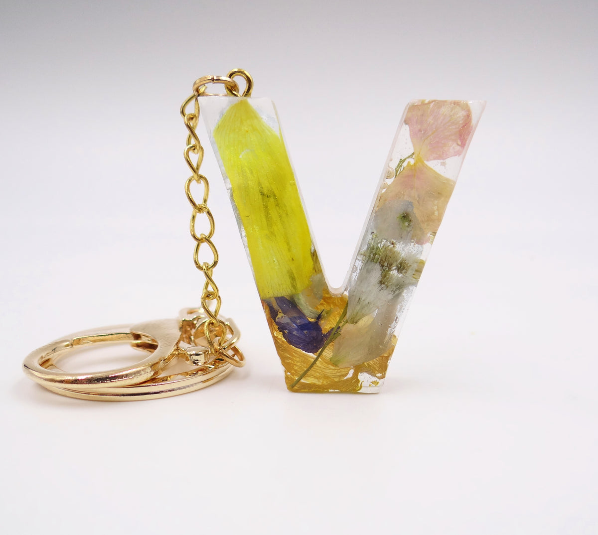 Resin letter V keychain with assorted spring-colored preserved flower petals, personalized floral charm